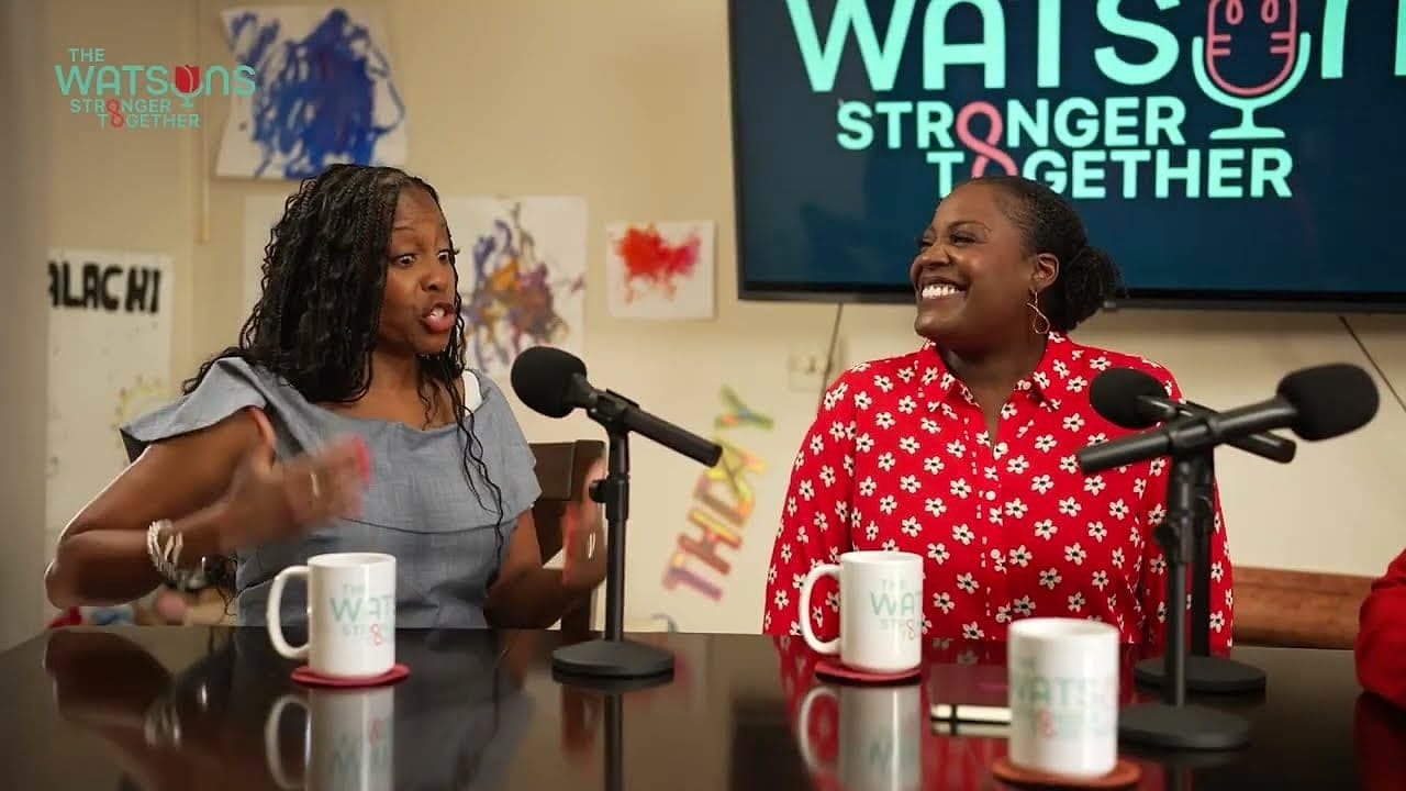Two women laughing into their microphones