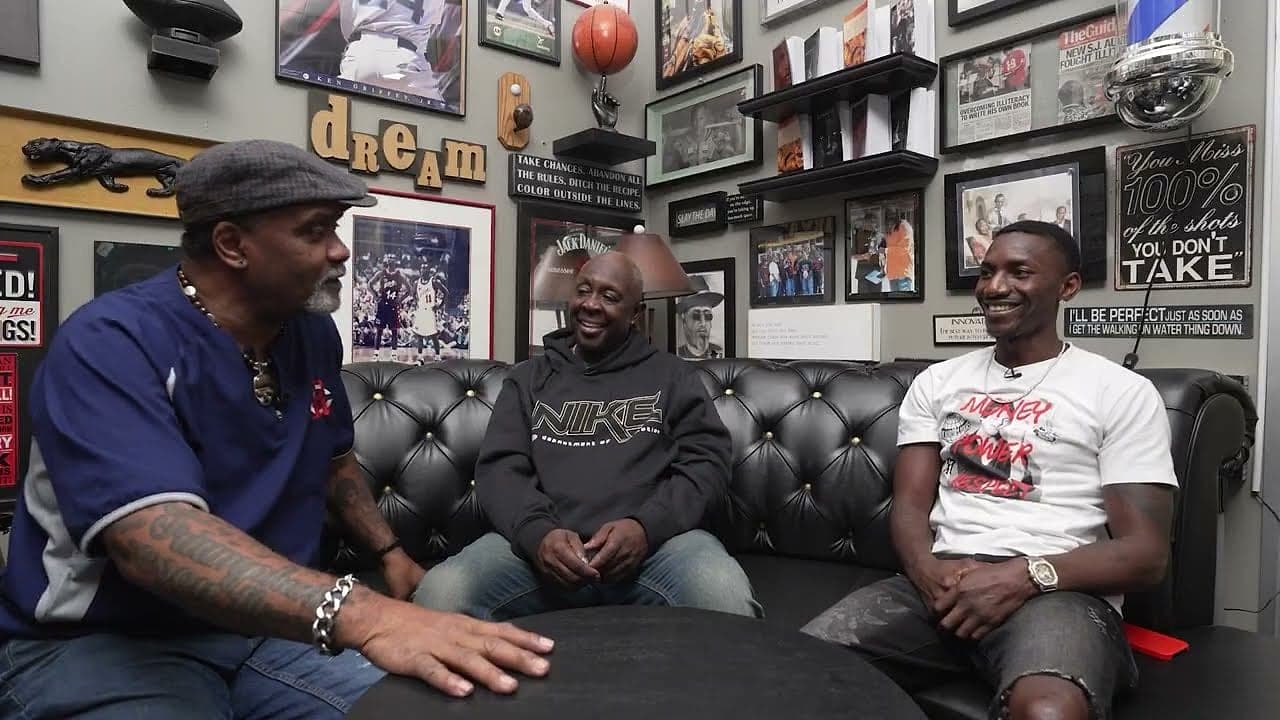 Doc and guests in conversation on the barbershop couch